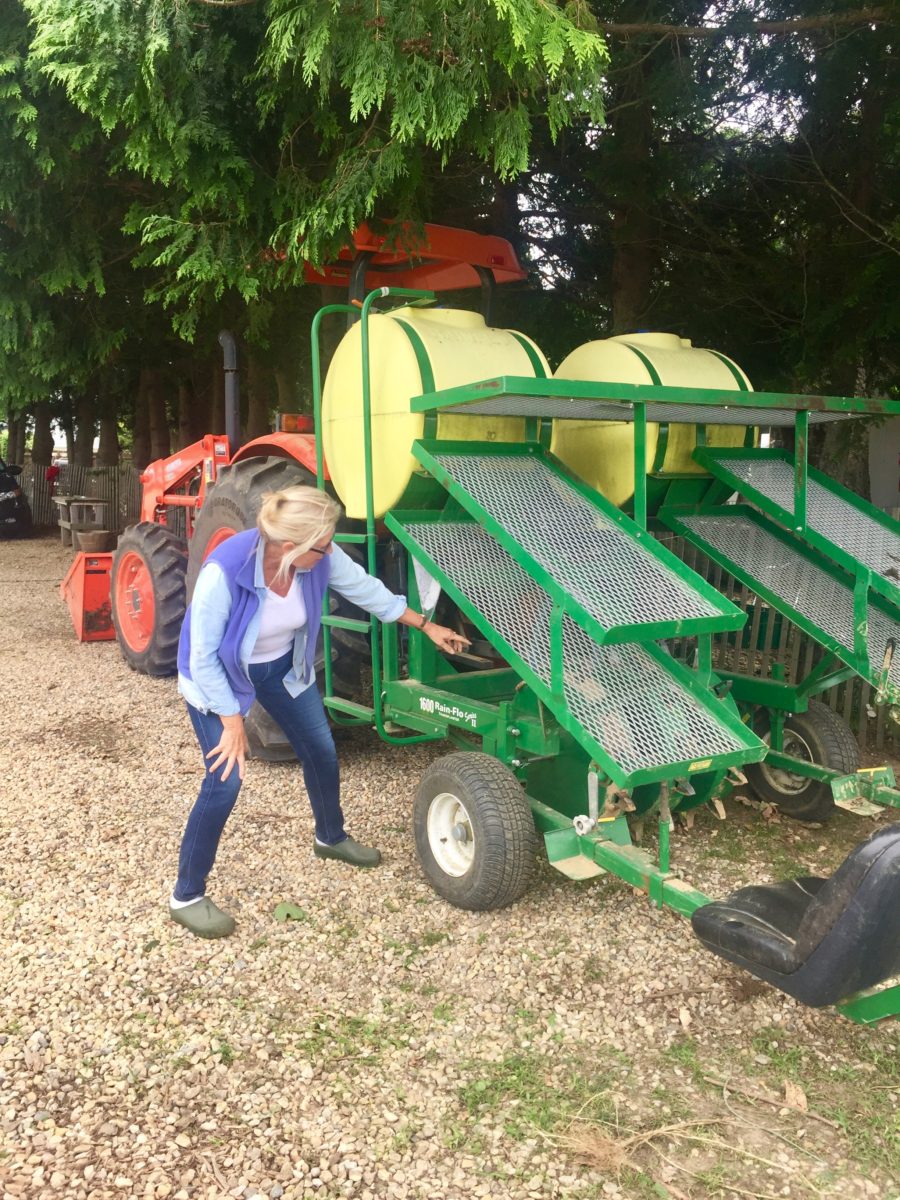 Denise showing me the seeding machine at Amber Waves Farm