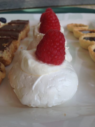 Mini Pavlovas with whipped cream and raspberries