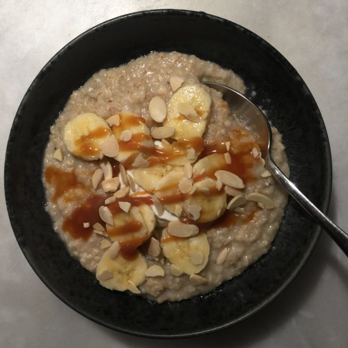 porridge or oatmeal with bananas, creme fraiche, caramel and slivered almonds